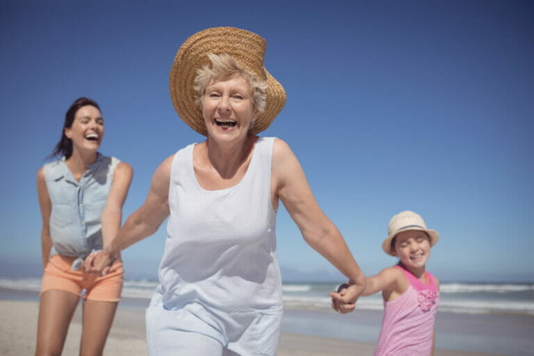 cheerful multi-generation family at beach