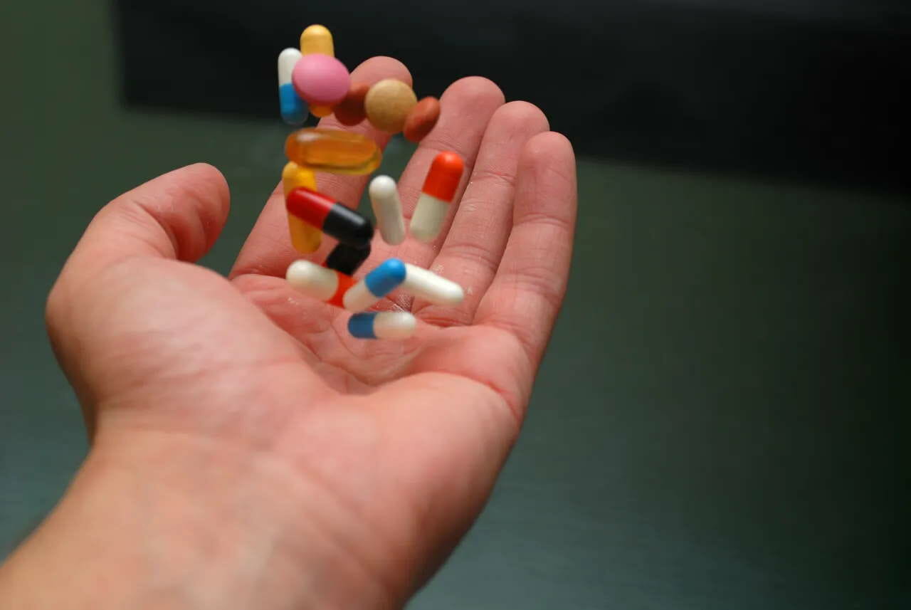 man tossing medicine