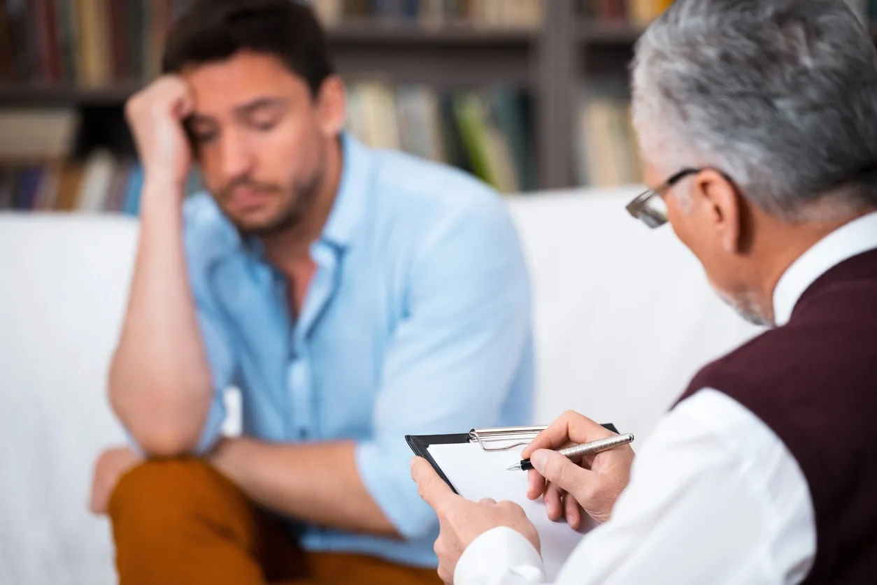man looking stressed getting treatment