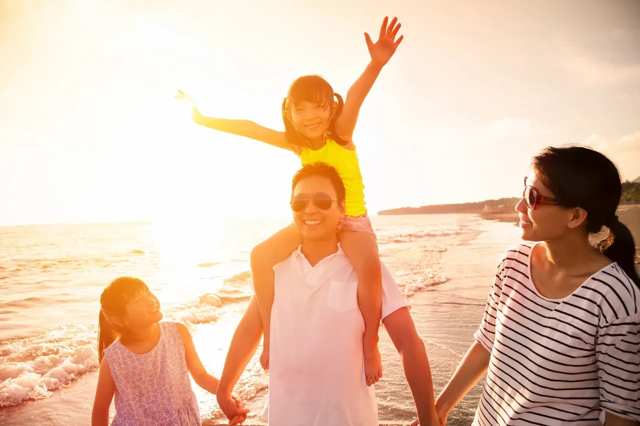 family on the beach during sunset