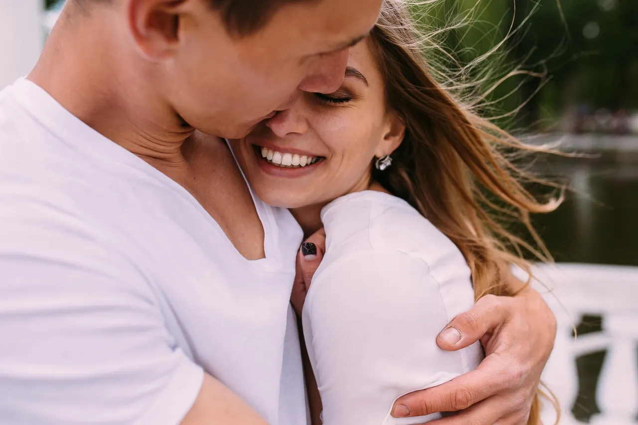 happy man and woman hugging each other