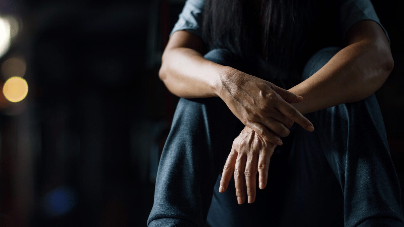 person holding their wrist as a form of self-comforting