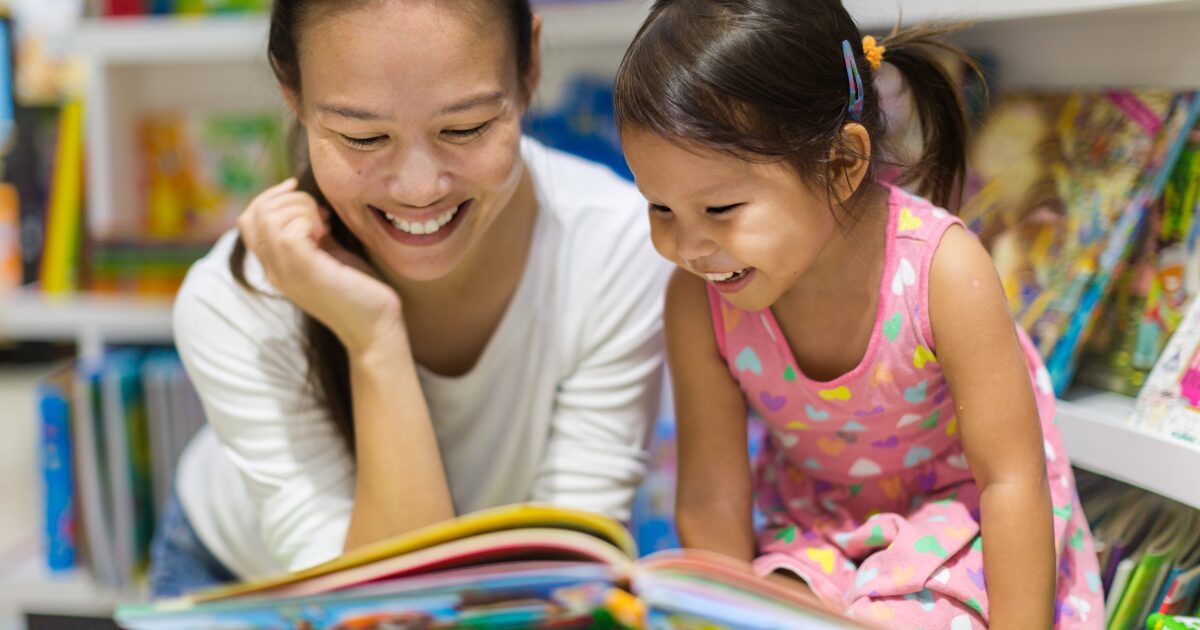 mother reading a book with her daughter